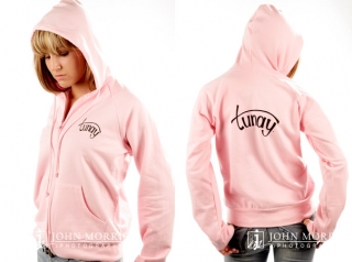 Fashion model, in studio, wearing a pink hoodie for a commercial apparel photo shoot in San Diego
