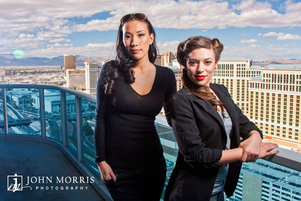 Poker players Amanda Musumeci and Evelyn Ng pose for a dramatic shot high above the Las Vegas strip during a commercial, lifestyle photo shoot.
