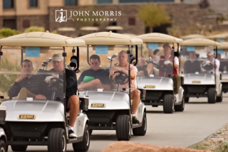 A traffic jam of golf carts heading out to the course in a shot gun start for a corporate golf outing.