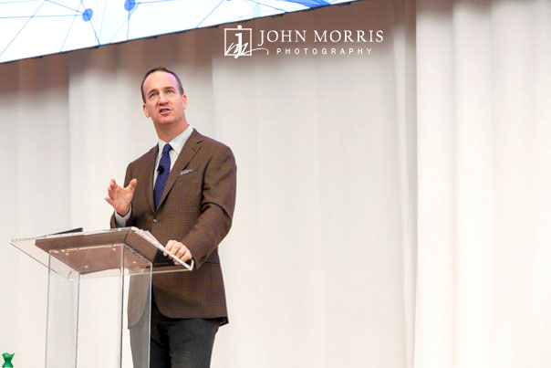 Peyton Manning making a point on stage during a talk for a corporate event at the Aspen Institute.