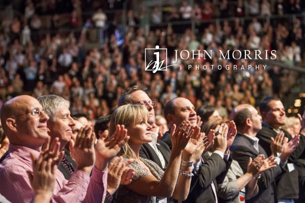 Enthusiastic audience applauding during a corporate event