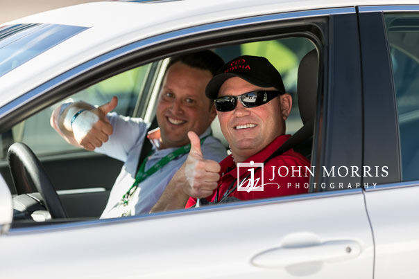 Attendees posing for the camera during a ride along at the Las Vegas Motor Speedway in Las Vegas as photographed by a San Diego Event Photographer