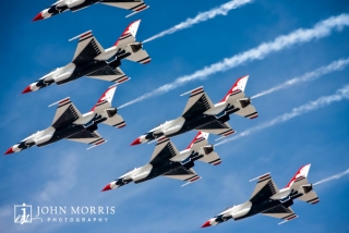 The US Air Force Thunderbirds fly in tight formation against a deep blue sky during a Nascar event in Las Vegas.