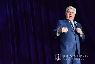 An animated Jay Leno, delivers one liners during on stage during a keynote speech.