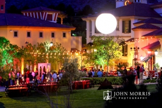 Gold cafe lights and a luminescent globe give an upscale fun feel to this outdoor networking event.