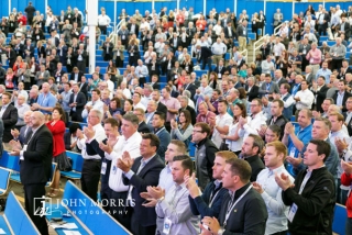 Standing ovation from a crowd of attendees at the Aspen Institute during a keynote speech.