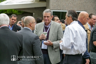 Attendees in business attire sharing ideas at an outdoor networking event in Aspen, CO.