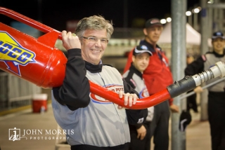 Happy attendee posing with a racing gas can at the Richard Petty Driving Experience in Las Vegas.