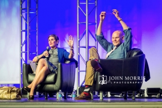 Animated speakers James Carville and Mary Matalin seated on stage, during a keynote.