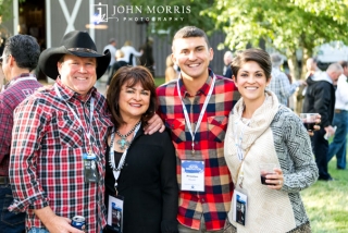 Executive and his family smiling for the camera during an outdoor networking event