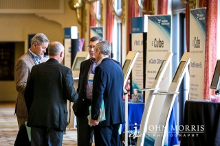 Four attendees sharing information during a trade show networking event