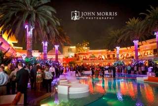Large convention crowd enjoying poolside networking party at the Encore Beach club in Las Vegas