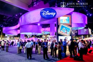Stunning Disney exhibit booth, full of attendees during a trade show in Las Vegas.