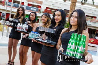 Cocktail waitresses lined up and ready to greet attendees with wine and beer at an outdoor networking event at the Encore Beach Club in Las Vegas.